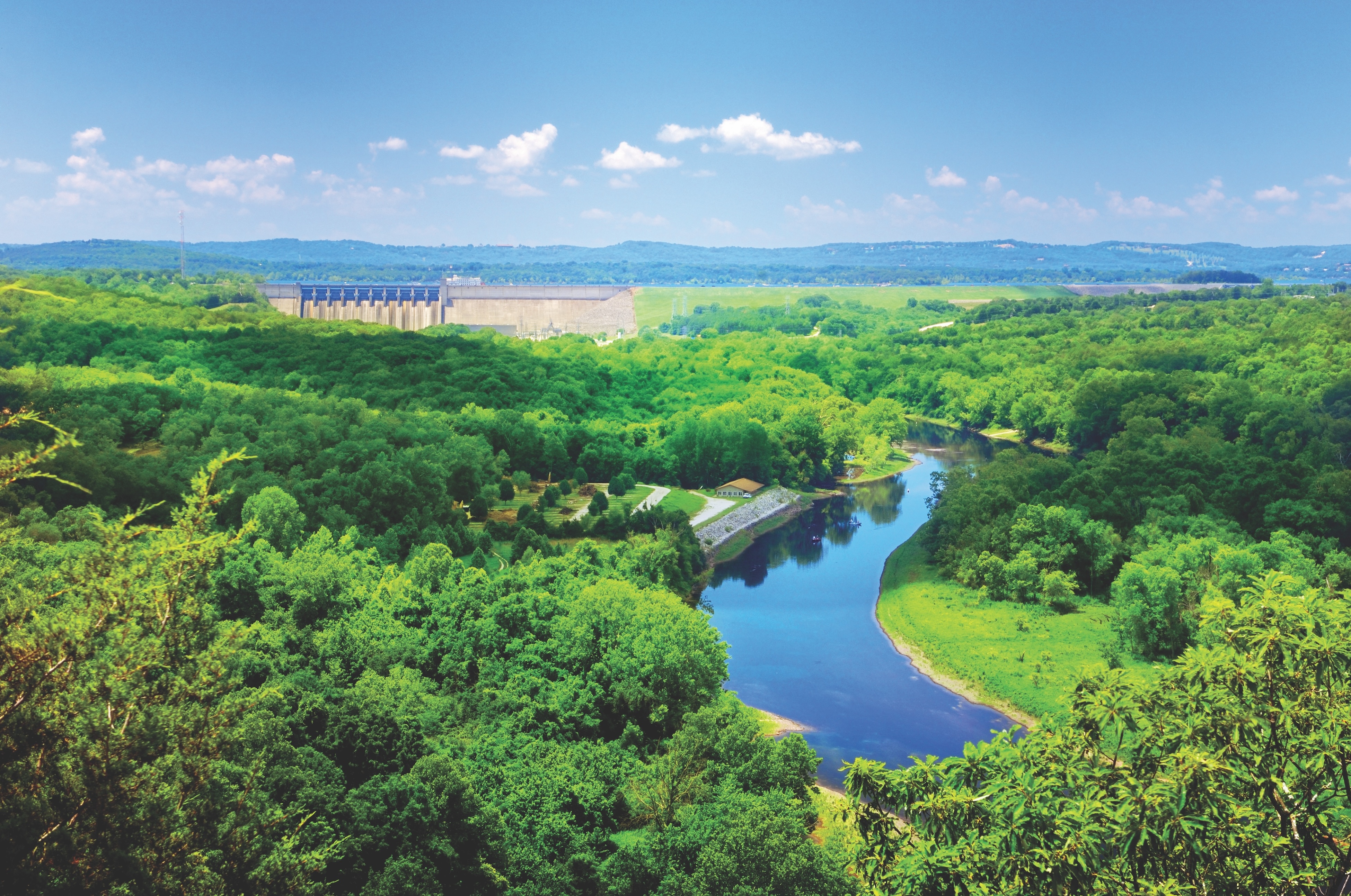 View of Table Rock Dam and Lake Taneycomo winding through the Ozark hills near Branson, Missouri on a sunny day.