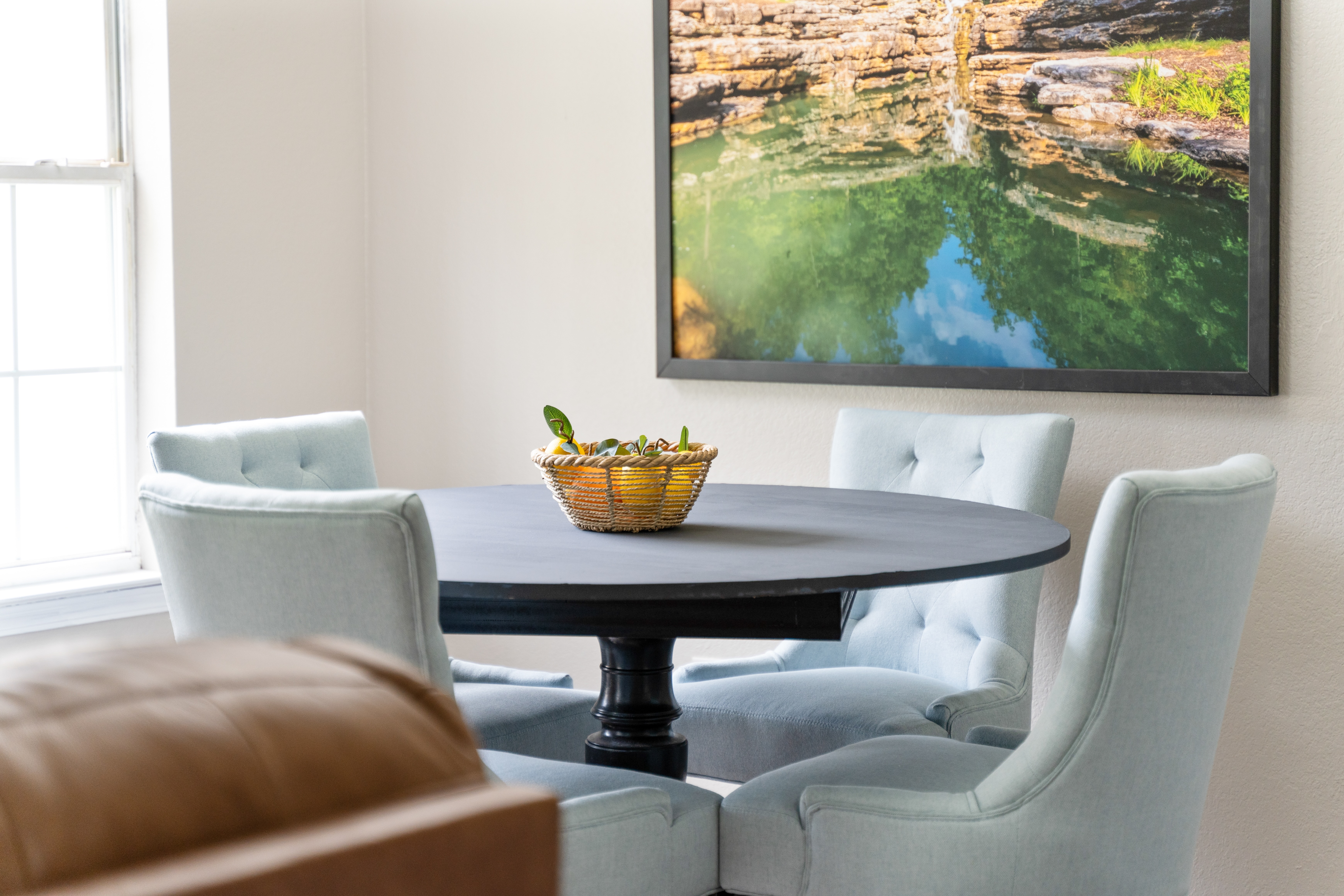 Dining area in Branson vacation rental featuring local artwork and bright decor