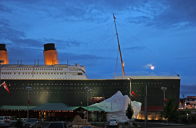 Titanic Museum attraction in Branson Missouri at dusk with the large ship replica exterior illuminated against a blue evening sky