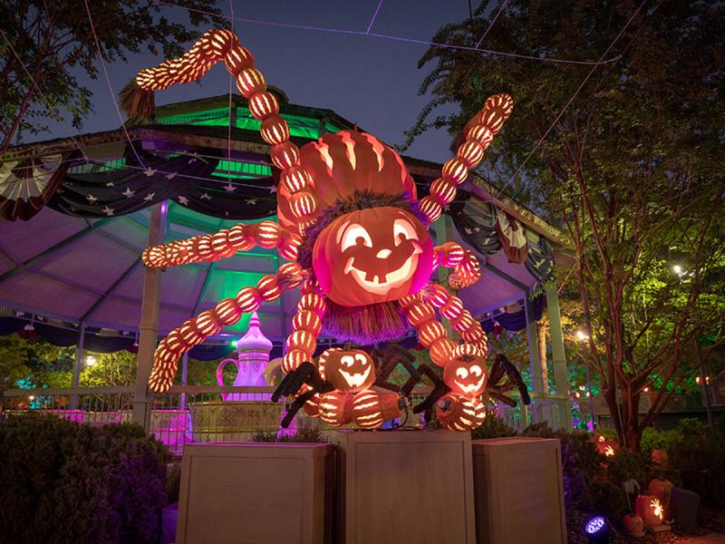 Giant illuminated pumpkin spider decoration during Harvest Festival at Silver Dollar City in Branson, Missouri.